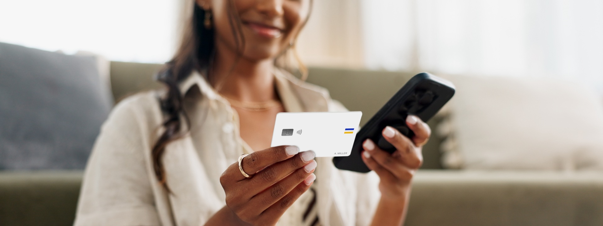 Woman holding white Visa-branded card