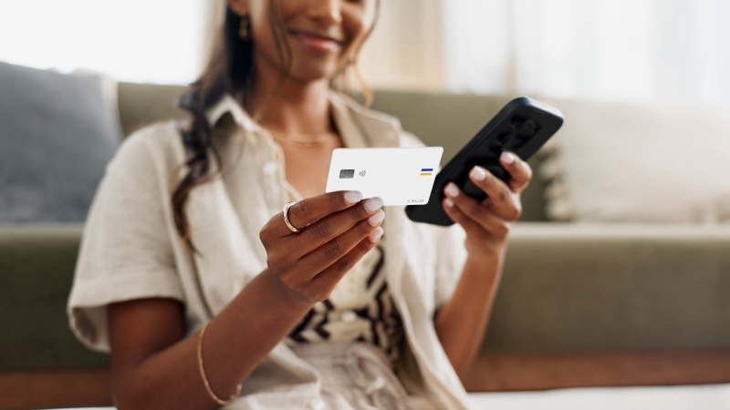 Woman holding white Visa-branded card